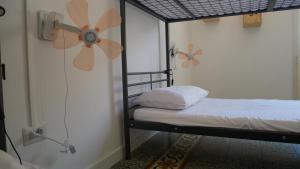a bedroom with a bed and a window at Urban Oasis Hostel in Lecce
