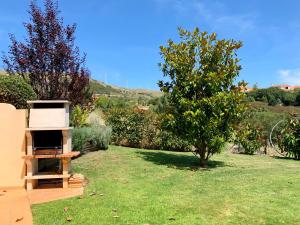 a garden with a beehive next to a tree at Villa with swimming pool in Golf Resort in Torres Vedras