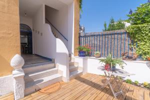 a porch with stairs and a fence with plants at Rosanna Maison in Ischia