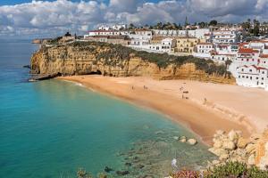 a view of a beach with white houses on a cliff at Rocha Brava Village Resort in Carvoeiro