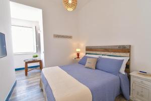 a bedroom with a large bed and a television at Rosanna Maison in Ischia