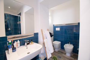 a bathroom with a sink and a toilet at Rosanna Maison in Ischia