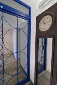 a grandfather clock and a mirror in a room at Rosanna Maison in Ischia