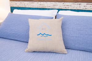 a pillow with a fish on it sitting on a bed at Rosanna Maison in Ischia