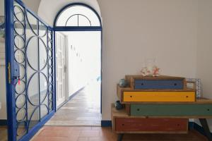a hallway with a door with a mirror and a dresser at Rosanna Maison in Ischia