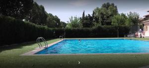 a large blue swimming pool in a yard at Casa Rural Barracas in Barracas