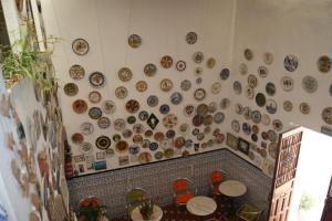 a wall full of plates on a wall at Hostal Alcázar in Córdoba