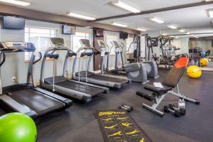 a gym with several treadmills and exercise bikes at Diamond Head Beach Resort in Fort Myers Beach