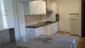 a kitchen with a table with a bowl of fruit on it at Casa vacanze Mare in Parghelia