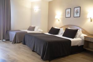 Säng eller sängar i ett rum på Hotel Maruxia *** Superior