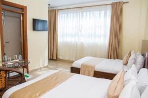 Postel nebo postele na pokoji v ubytování Delfirm Hotel