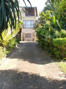 a brick walkway in front of a building at 57 Simon Van Der Stel Street in Port Edward