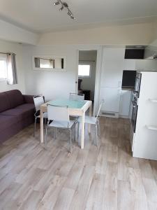 a living room with a table and a couch at Village Guerzaille in Saint-Caradec +12 photos