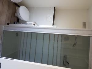 a white box sitting on top of a bathroom shelf at Village Guerzaille in Saint-Caradec