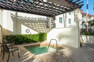 a patio with a swimming pool and a pergola at Bellasera Resort in Naples