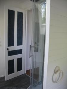 a glass shower door next to a white wall at La maison in Tarnac +42 photos