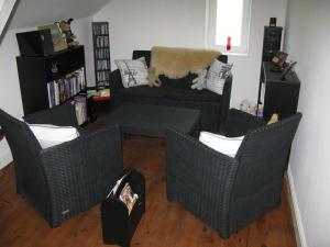 a living room with three wicker chairs and a couch at La maison in Tarnac