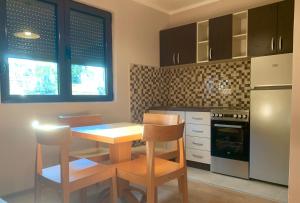 a kitchen with a table and chairs and a stove at City Centre in Žabljak +8 photos