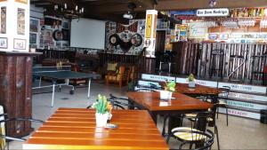 a restaurant with wooden tables and chairs in a room at Country House Alfarim in Alfarim