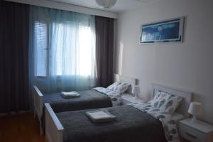 a hotel room with two beds and a window at RANTA in Tampere