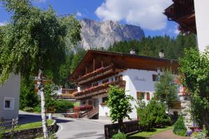 a hotel with a mountain in the background at Garni Flurida in Badia