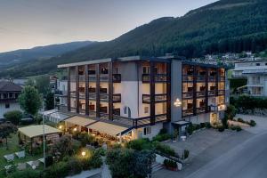 an aerial view of a building with mountains in the background at Hotel Kristall in Falzes