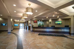 a lobby of a hospital with a waiting area and chandeliers at Acclaim Hotel by CLIQUE in Calgary