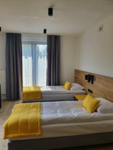 A bed or beds in a room at VILLA 17 Noclegi