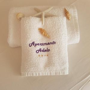 a towel with the words apartments citida on it at Adela Apartments - Beach Žnjan Split in Split +102 photos