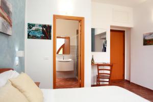 a bedroom with a bed and a bathroom with a mirror at Country Villa San Vito Bay in San Vito lo Capo