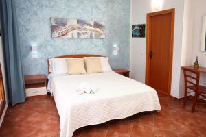 a bedroom with a bed with two towels on it at Country Villa San Vito Bay in San Vito lo Capo