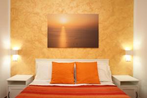 a bedroom with a bed with orange pillows at Country Villa San Vito Bay in San Vito lo Capo