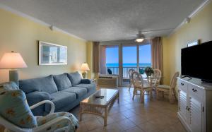 a living room with a couch and a table with chairs at Carolina Winds in Myrtle Beach