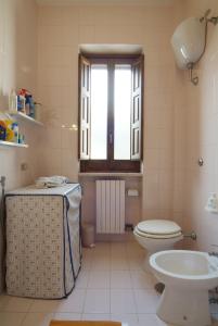 a bathroom with a toilet and a sink and a window at The Sea View Mountain Apartment in Fasano +27 photos
