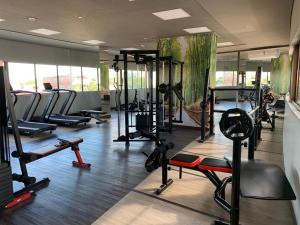 a gym with several treadmills and machines in a room at Flat novo no Complexo Heron Marinho in Campina Grande