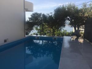 a swimming pool with a view of the water at Apartmani Milka i Jozo in Omiš