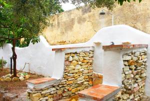 a stone fireplace in front of a wall at Country Villa San Vito Bay in San Vito lo Capo