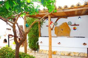 a house with a tree in front of it at Country Villa San Vito Bay in San Vito lo Capo