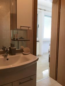 a bathroom with a sink and a mirror at apartmani Isabella - Ilda Radonic in Jelsa