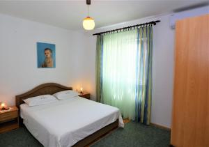 Postel nebo postele na pokoji v ubytování Apartmani Vinko