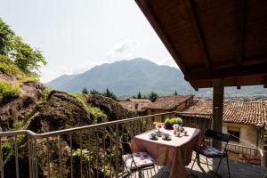 uma mesa numa varanda com vista para as montanhas em Sentirsi a Casa em Boario Terme