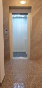 a door leading to a bathroom with a toilet at HARMONY in Sozopol