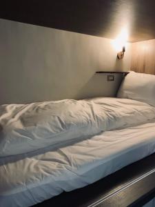 Postel nebo postele na pokoji v ubytování Dan Hostel丹居青旅
