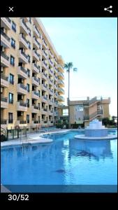 a large swimming pool in front of a large building at nice apartment in hotel ronda 4 first beach line in Fuengirola
