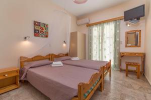 A bed or beds in a room at Andreas Apartments