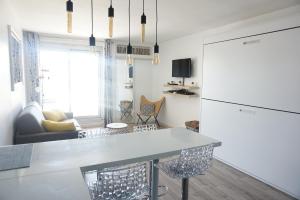 a kitchen and living room with a table and a couch at Studio Victoria Surf in Biarritz