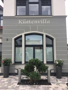 a building with a sign on the side of it at Küstenwilla FeWo Usedom in Zinnowitz