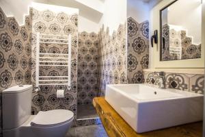 a bathroom with a white sink and a toilet at B&B La Mia Valigia in San Lucido