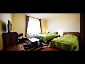 A bed or beds in a room at Spirit Apartman