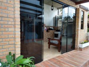 a glass door leading to a patio with a table at Hospedaria Gaúcha in Penha